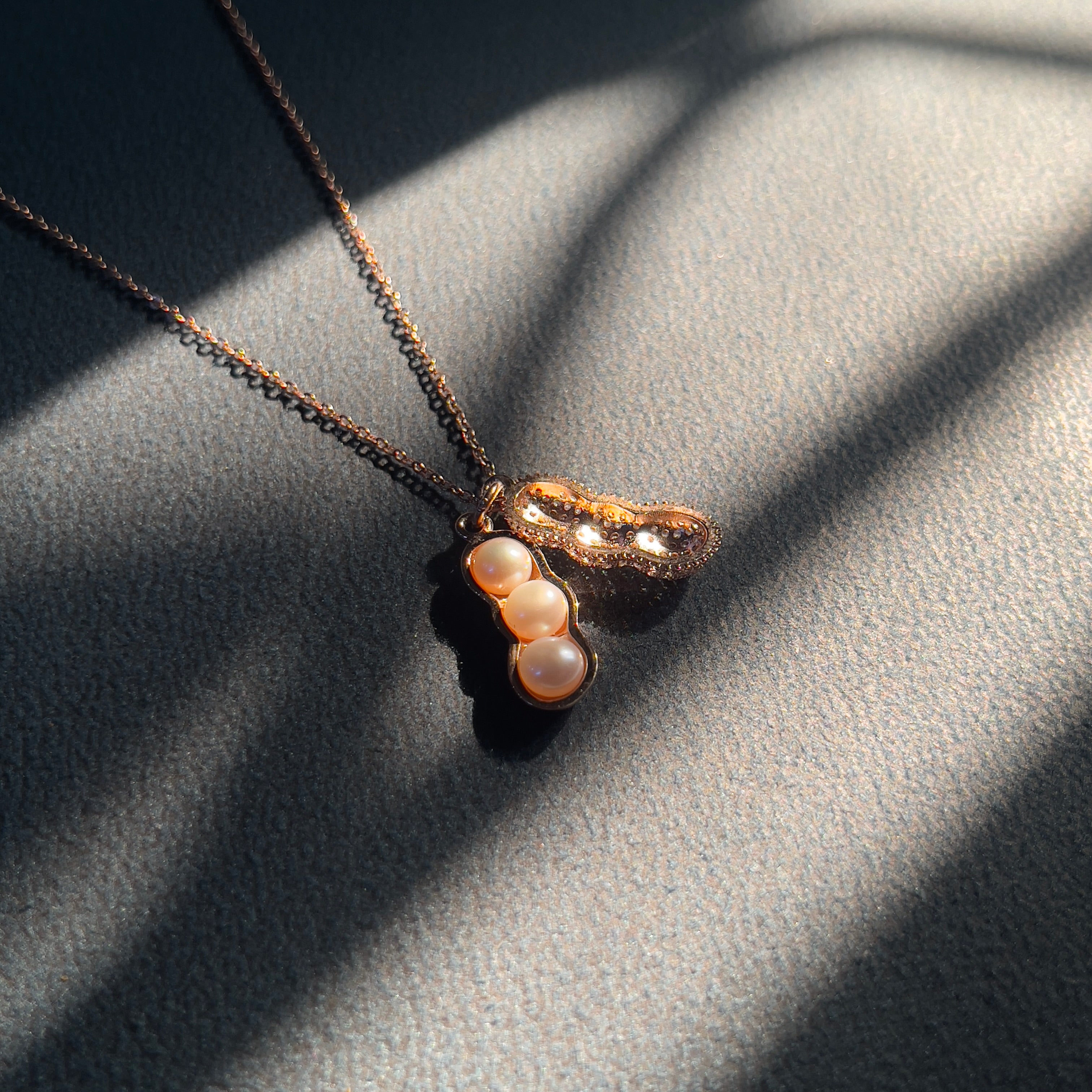 925 sterling silver and plated with luxurious rose gold, this peanut pendant necklace