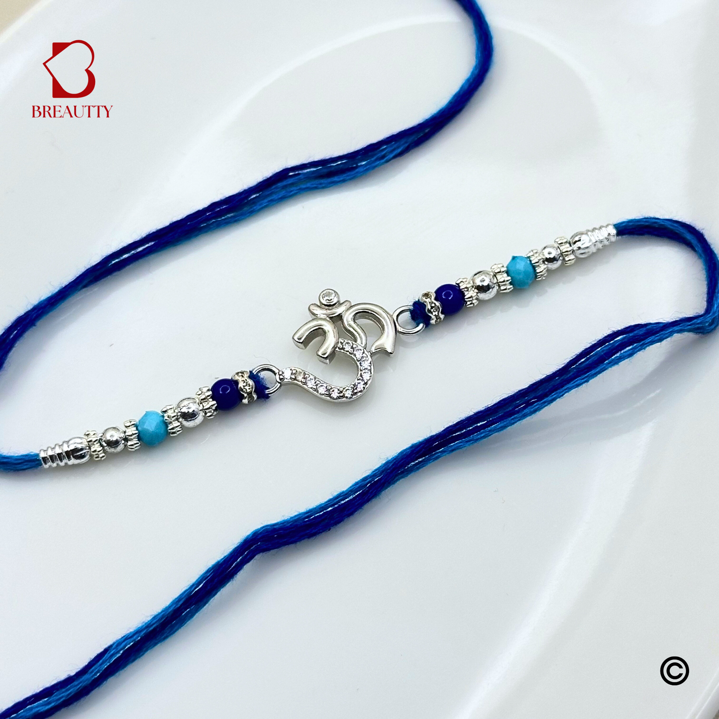 BREAUTTY RAKSHA BANDHAN 925 STERLING SILVER RAKHI  "OM"  WITH BLUE THREAD  | HALLMARKED SILVER  RAKHI