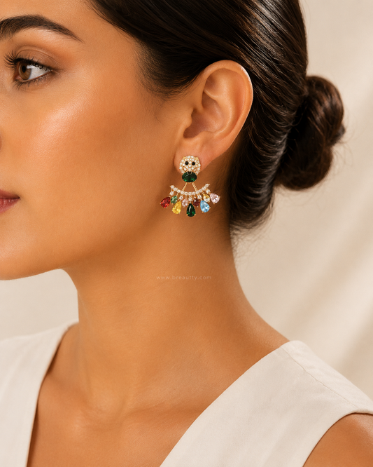 Close-up of a woman wearing a colorful earring with a neutral background